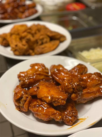 A plate of chicken wings in a glaze sauce.