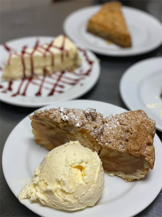 A plate with vanilla ice cream and a slice of apple pie.